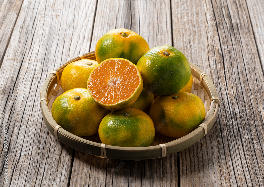 Early Japanese mandarin oranges on an old wooden board