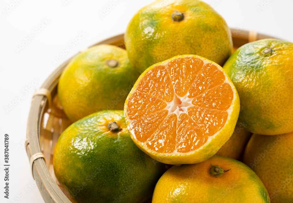 Early Japanese mandarin oranges in a colander