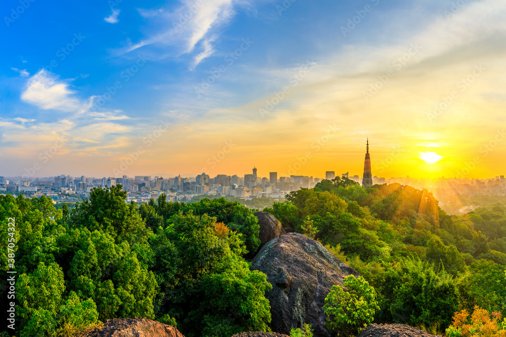 Ancient Baochu Pagoda.Chinese traditional architecture and modern city skyline in Hangzhou at sunris