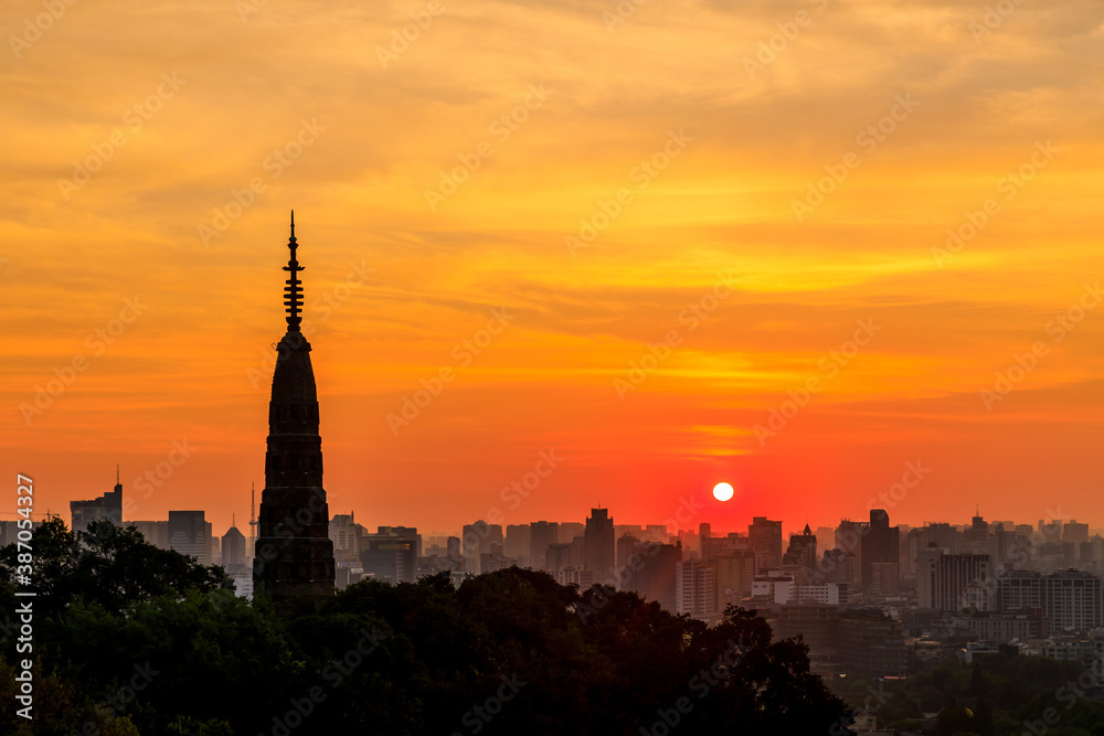 Ancient Baochu Pagoda.Chinese traditional architecture and modern city skyline in Hangzhou at sunris