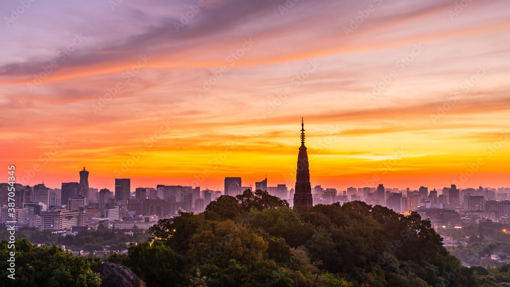 Ancient Baochu Pagoda.Chinese traditional architecture and modern city skyline in Hangzhou at sunris