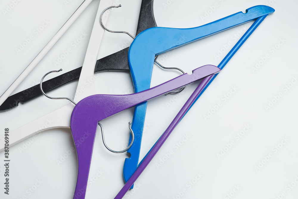 Clothes hangers on light background