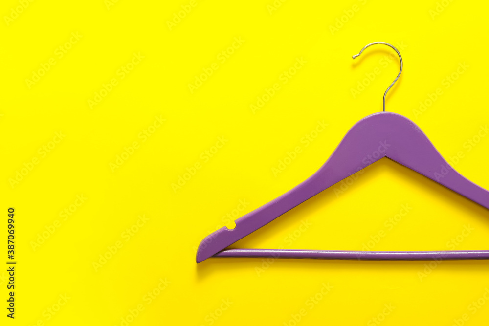 Clothes hanger on color background