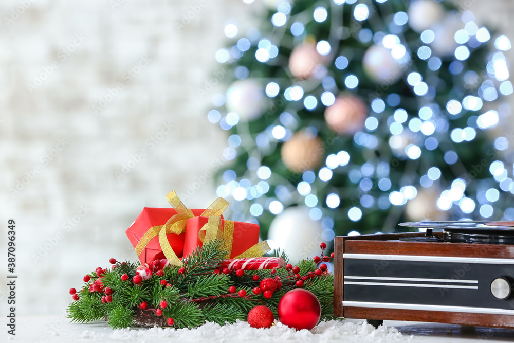 Record player and Christmas decor on table