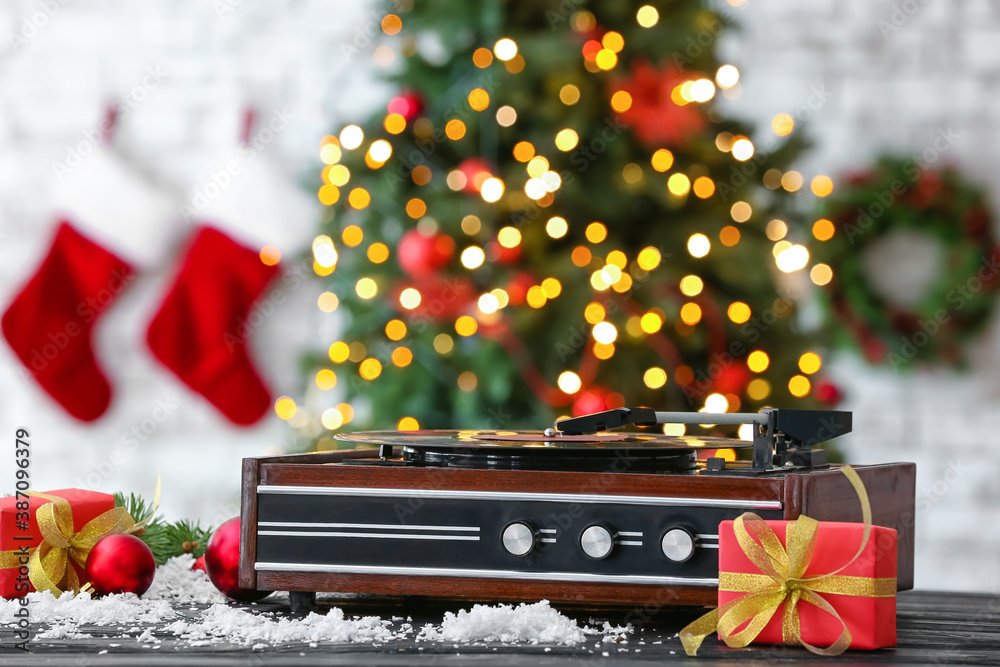 Record player and Christmas decor on table