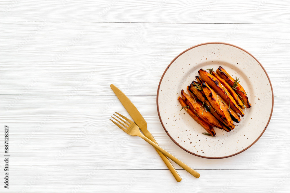 Overhead view of sweet potato fries with spices and herbs