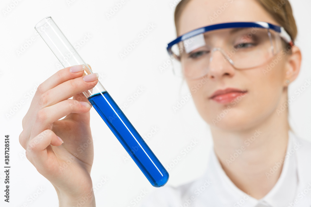 Beautiful woman scientist in protective goggles