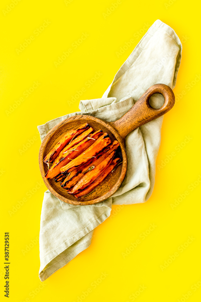 Sweet potato fries with spices on a wooden board, top view