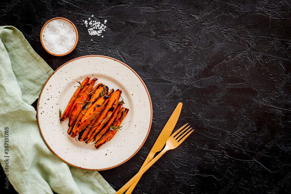 Overhead view of sweet potato fries with spices and herbs