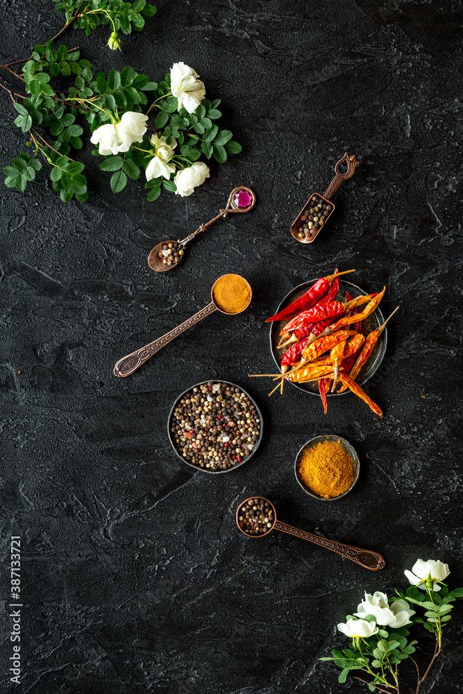 Hot spices set with herbs and flowers, top view