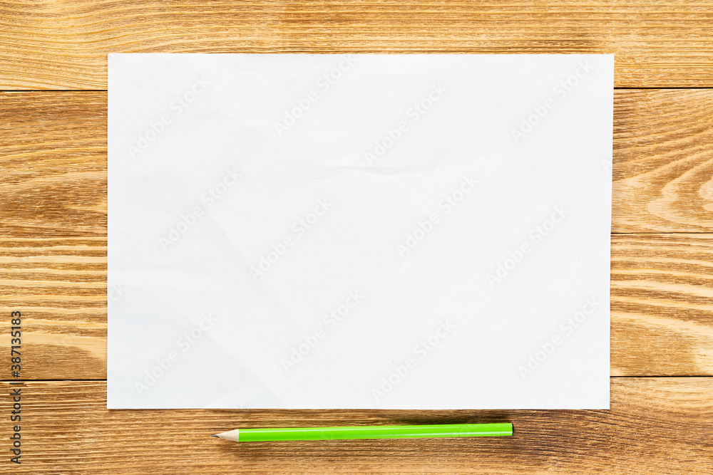 Sheet of paper lying on wooden table