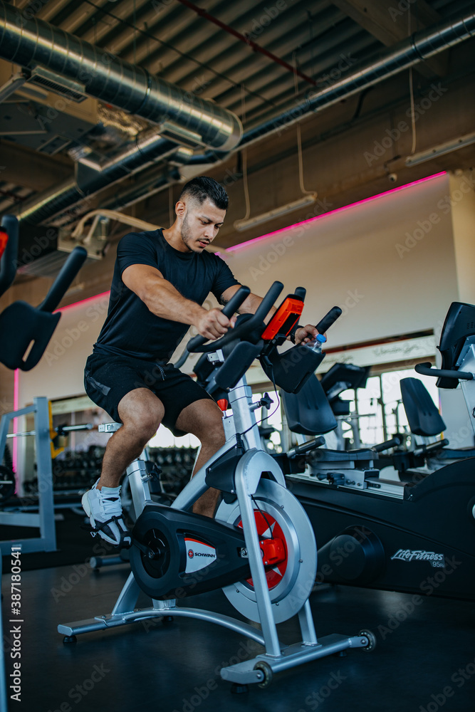 Muscle man, riding bike.