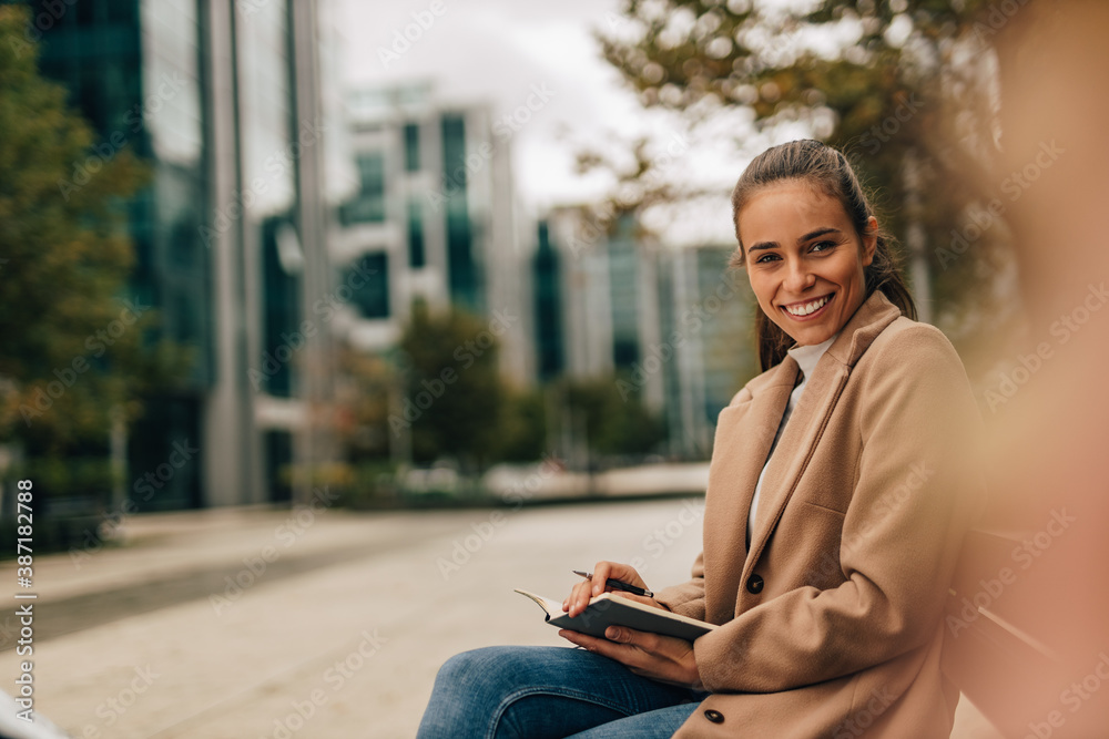 Focus on girl, buildings in the background.