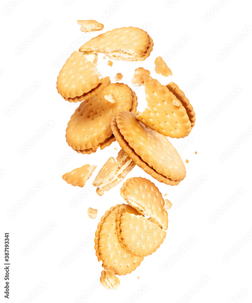 Delicious biscuits crushed in air, isolated on white background