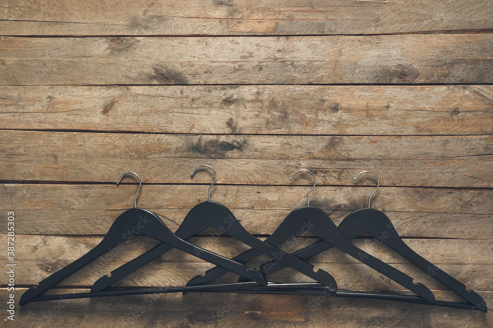 Clothes hangers on wooden background