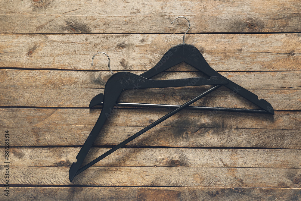 Clothes hangers on wooden background