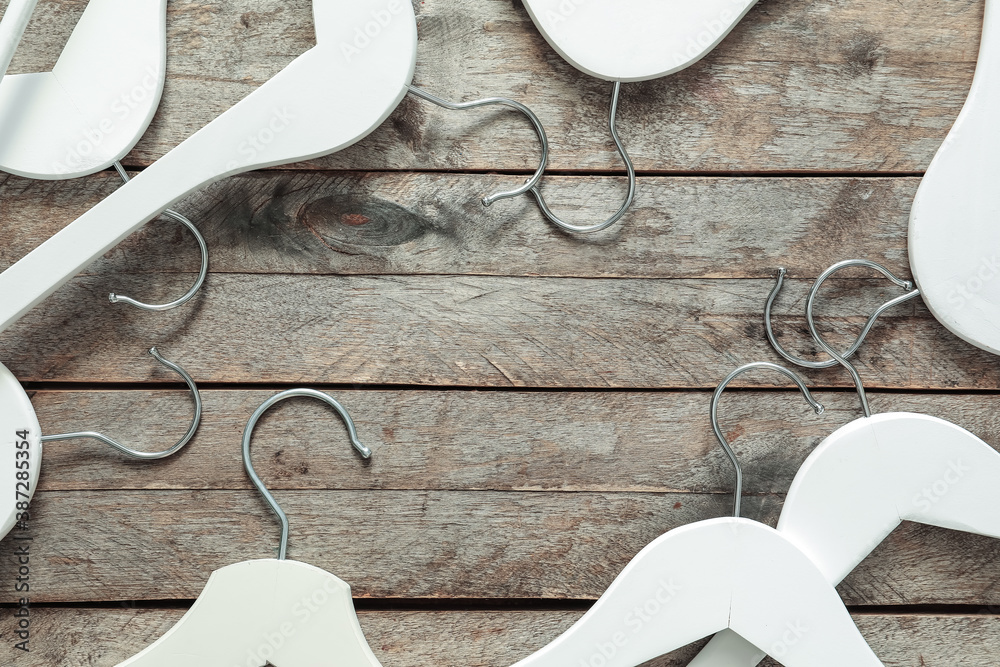 Composition with clothes hangers on wooden background