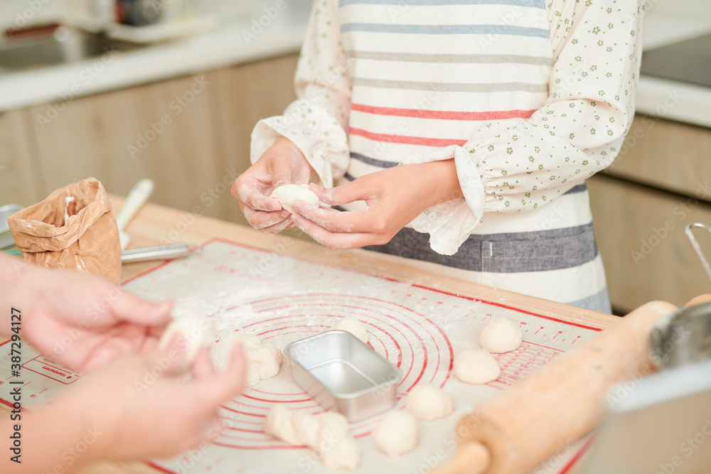 Woman kneading dough, close-up photo