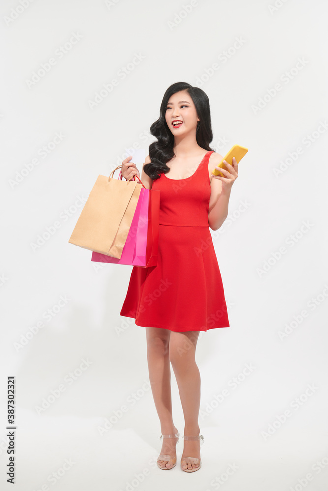 Happy Asian woman using cell phone