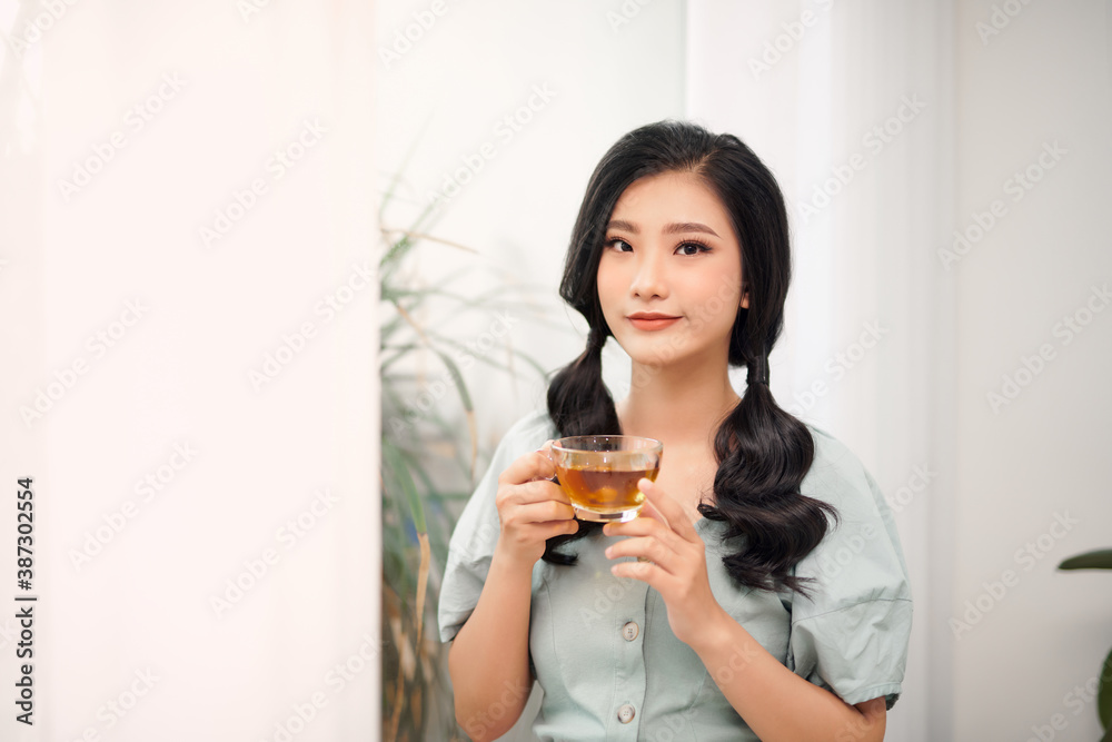 young attractive asian woman who drink tea