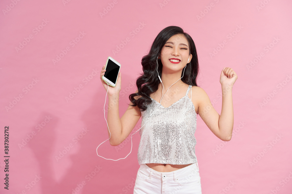 Lifestyle Concept - Portrait of beautiful asian woman joyful listening to music on mobile phone