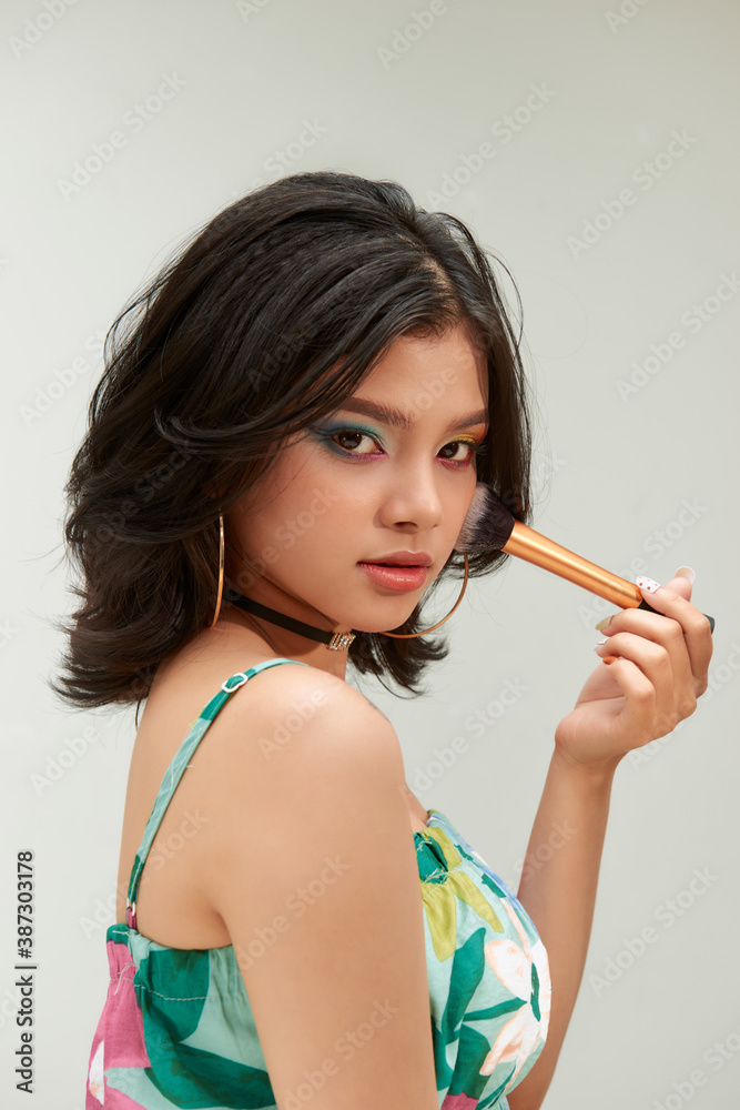 Beauty Woman with Makeup Brushes. Natural Make-up for asian Model Girl with rainbow eyeshadow.  Make