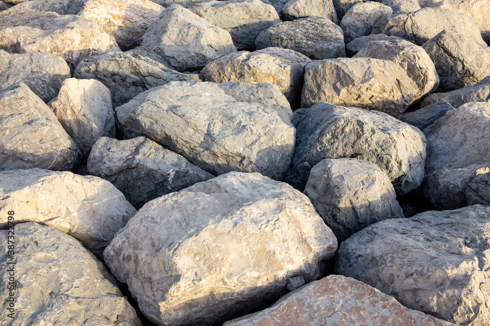 Big rough stones and rocks texture (background), forming a pier in Dubai.