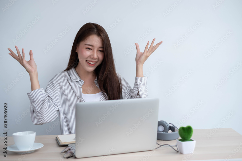 asian female use laptop computer and video call with friend in home, work from home concept.