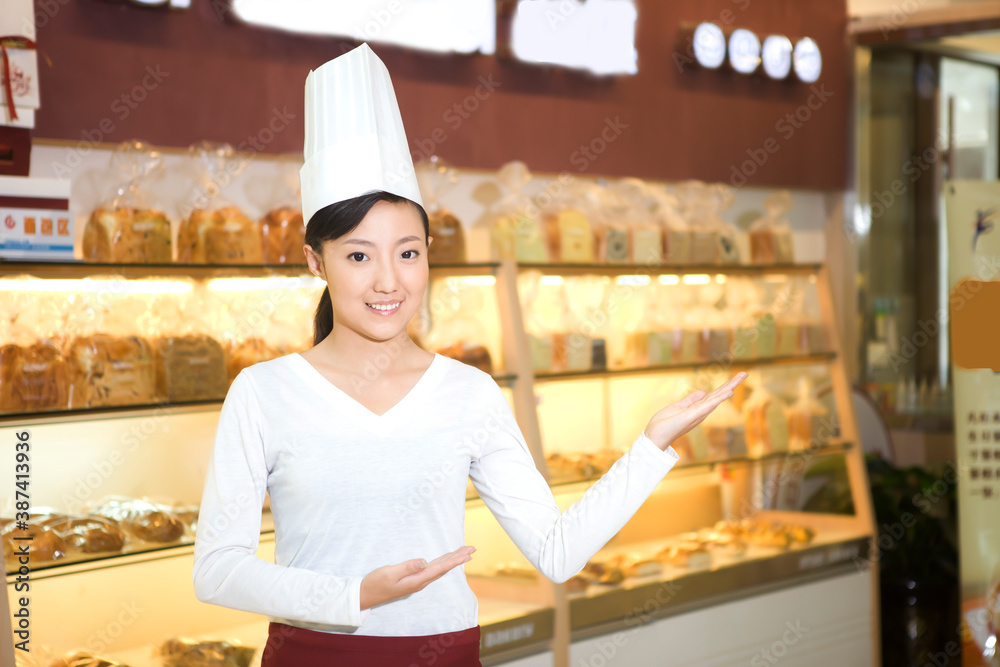 The happy bakery saleswoman is in the bakery 