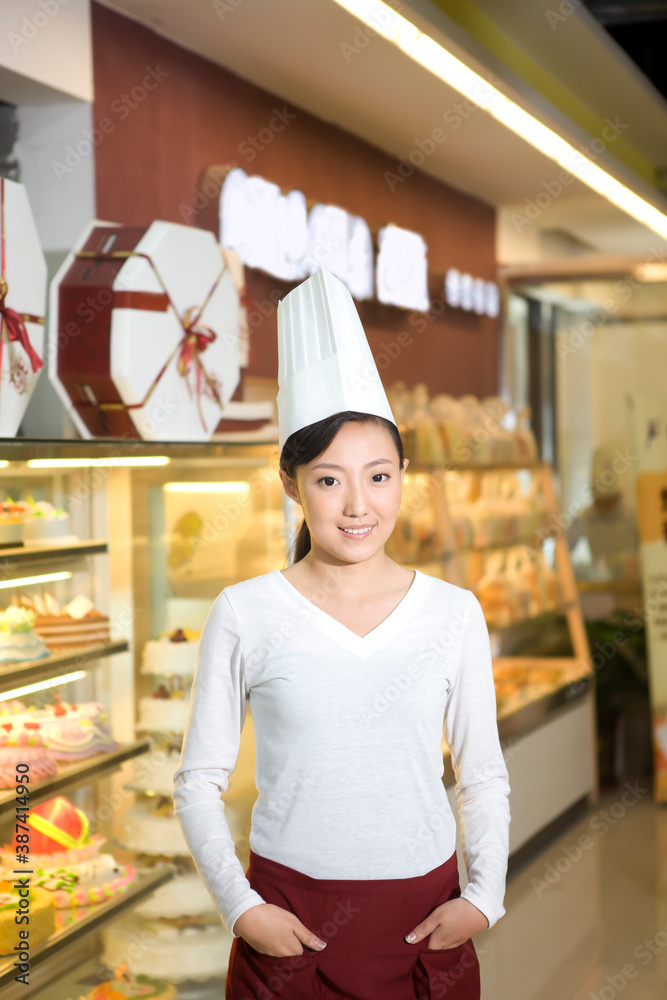 The happy bakery saleswoman is in the bakery