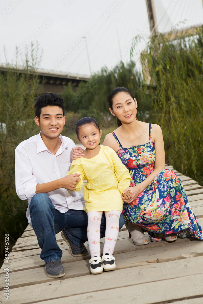 A happy family of three in the park for an outing