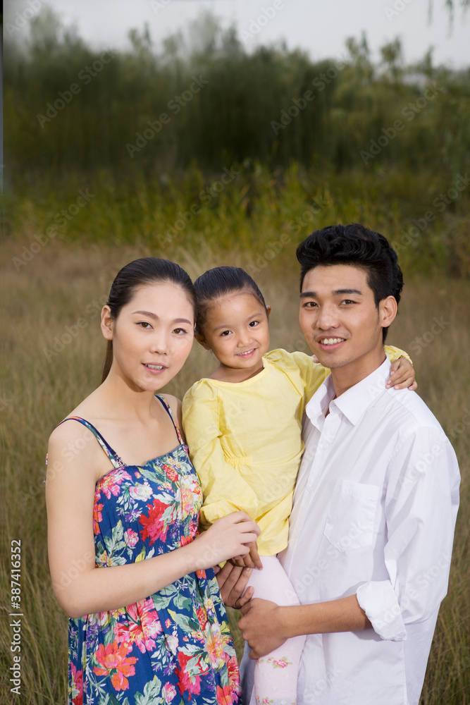 A happy family of three in the park for an outing