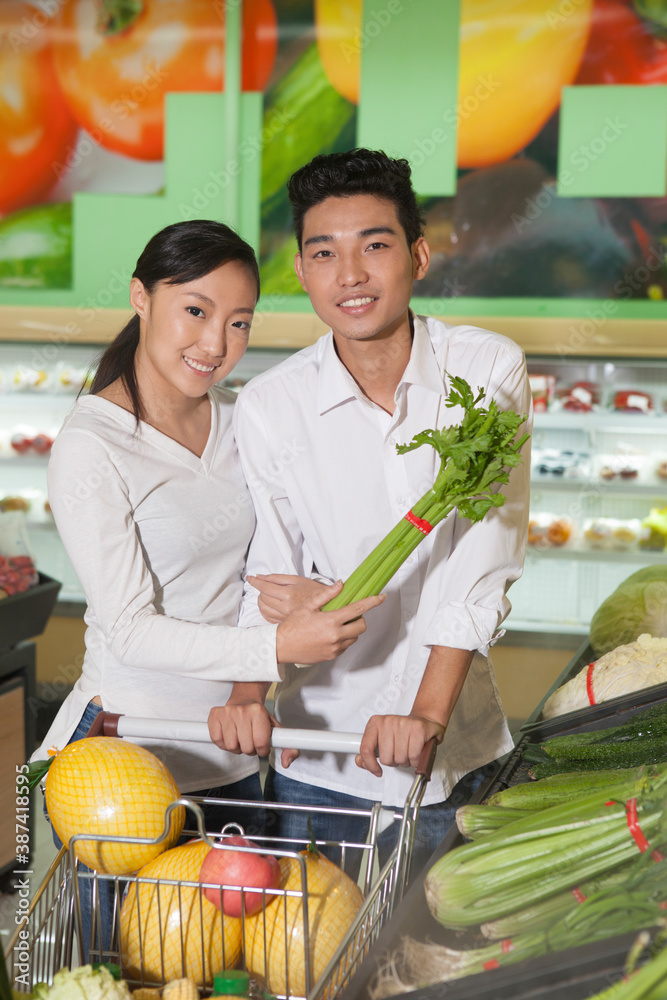 A young couple in the supermarket shopping