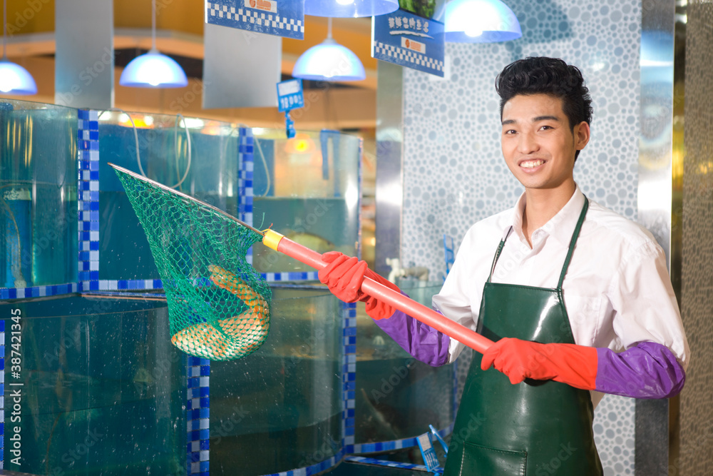 A supermarket seafood salesman with fish high quality photo