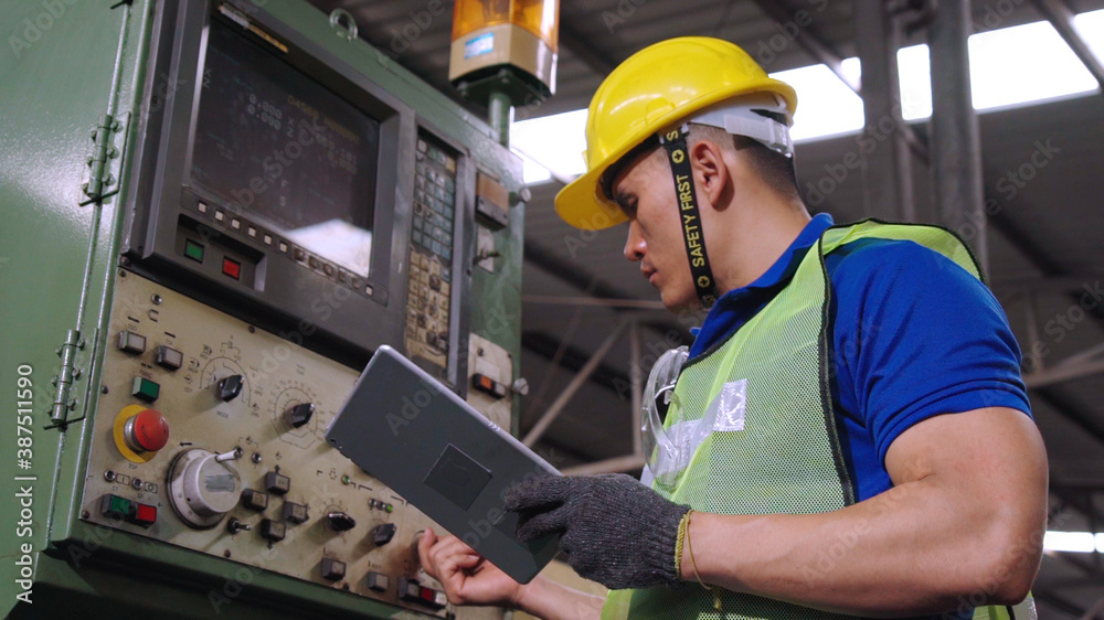 Smart factory worker using machine in factory workshop . Industry and engineering concept.