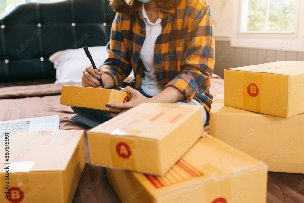 Close up Online shopping young women start small business in a cardboard box at work. The seller pre