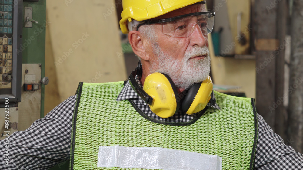 Senior factory worker or engineer close up portrait in factory . Industry and engineering concept .