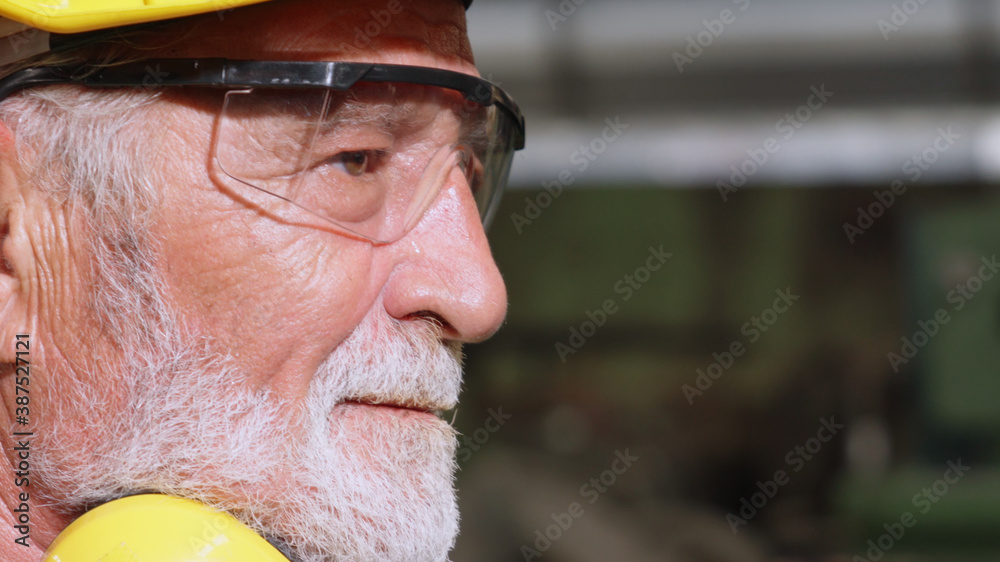 Senior factory worker or engineer close up portrait in factory . Industry and engineering concept .