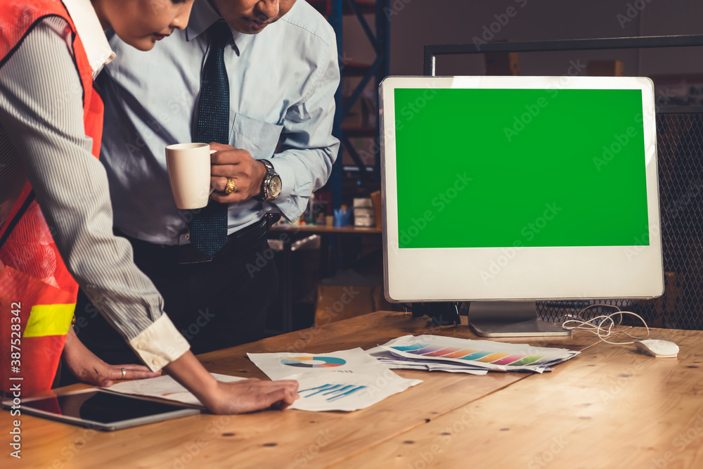 Computer with green screen display in warehouse storage room . Delivery and transportation software 