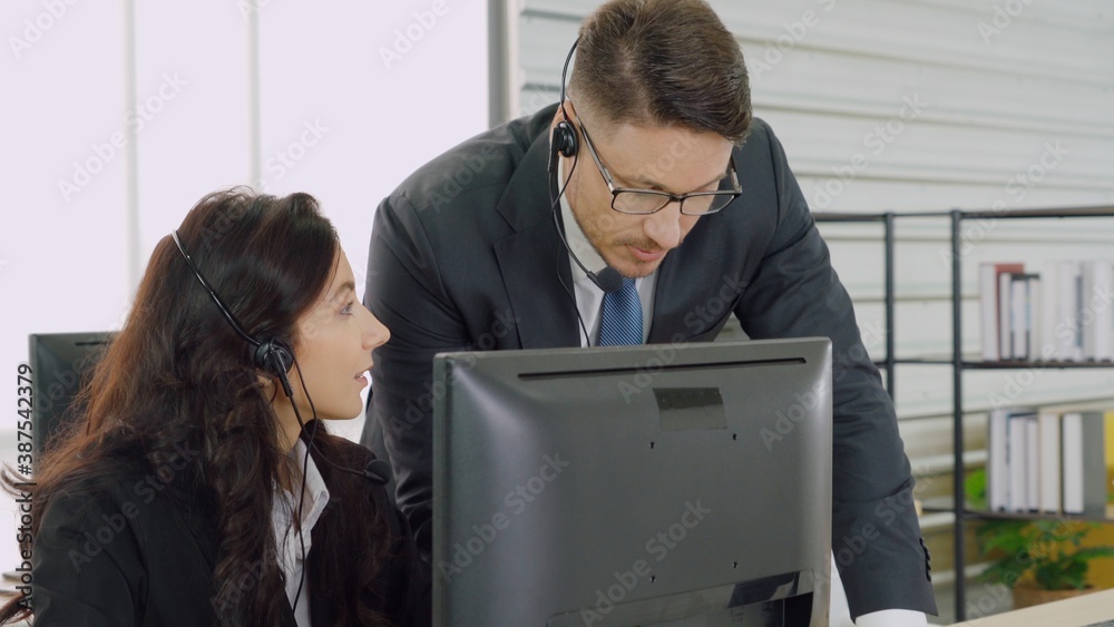 Business people wearing headset working in office to support remote customer or colleague. Call cent