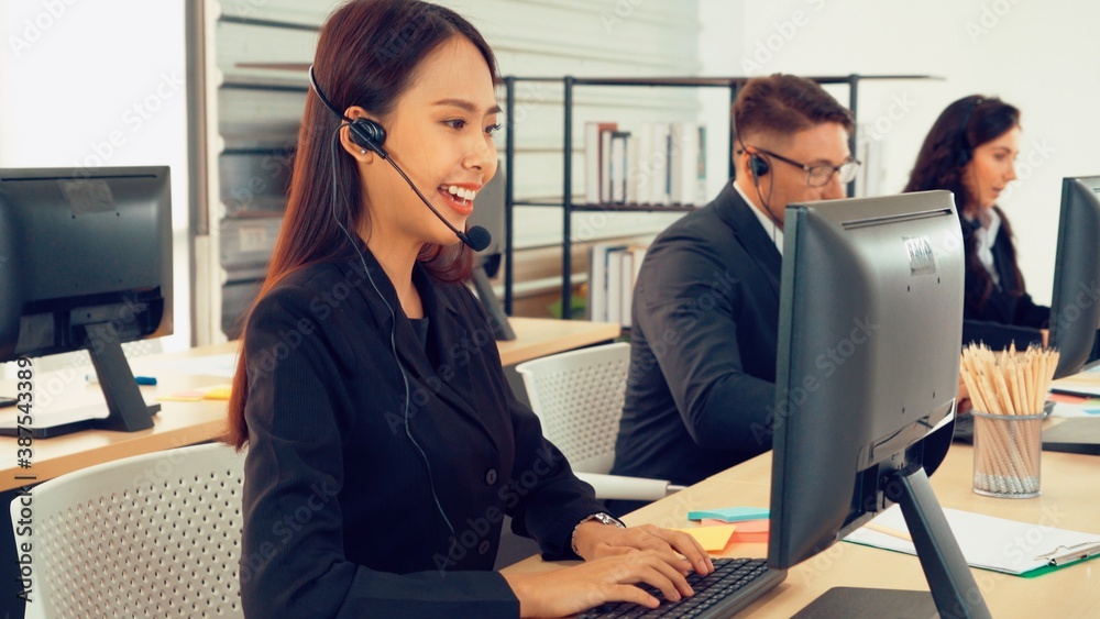 Business people wearing headset working in office to support remote customer or colleague. Call cent