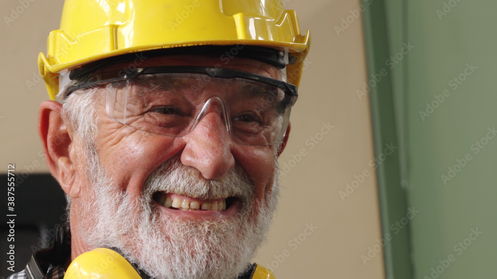 Senior factory worker or engineer close up portrait in factory . Industry and engineering concept .