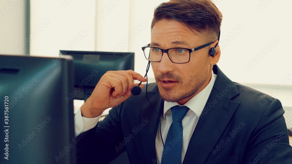 Business people wearing headset working in office to support remote customer or colleague. Call cent