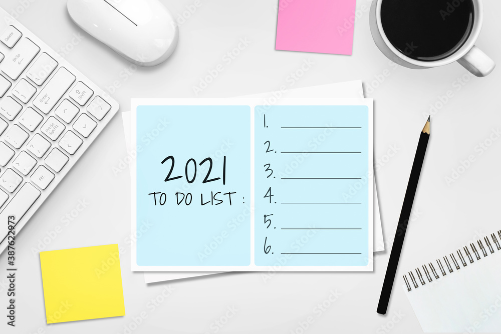 2021 Happy New Year Resolution Goal List - Business office desk with notebook written in handwriting