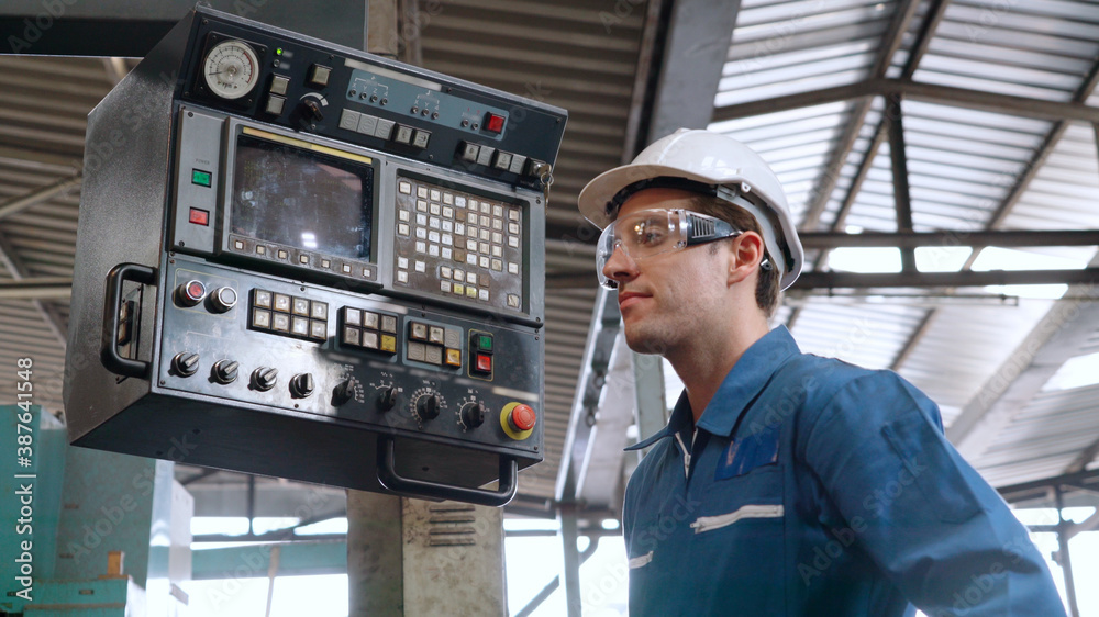 Smart factory worker using machine in factory workshop . Industry and engineering concept.