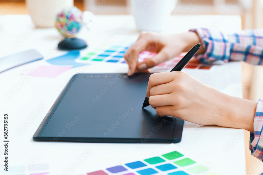 Graphic designer using her graphic tablet in a home office