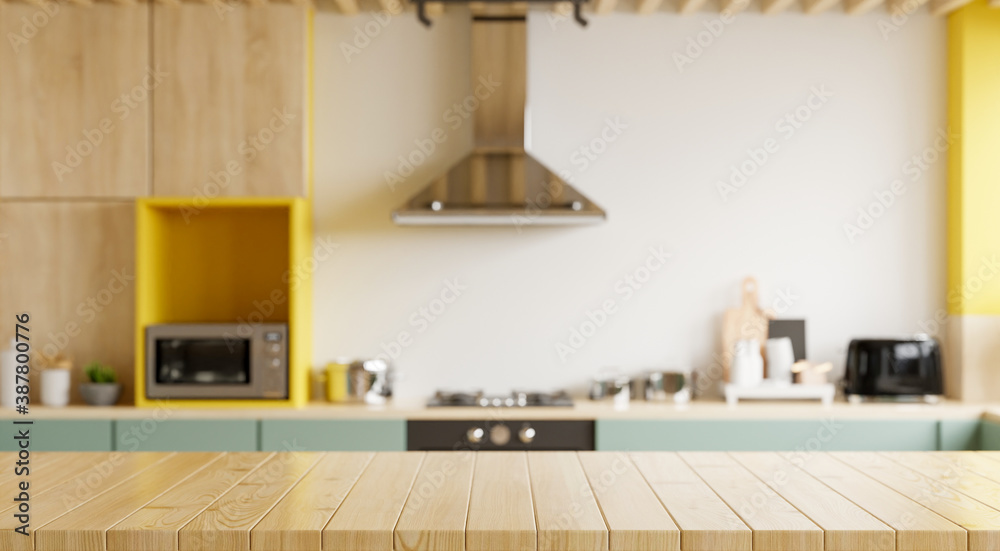 Empty wooden table and blurred kitchen yellow wall background/Wood table top on blur kitchen counter