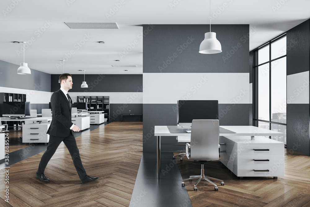 Businessman walking in modern office interior