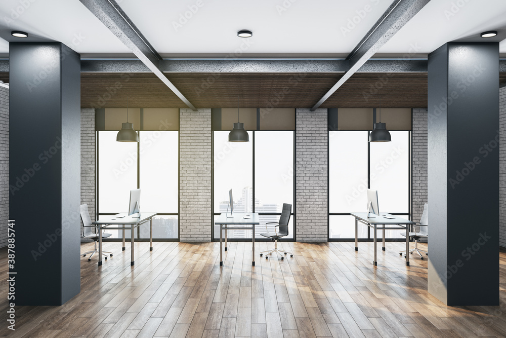 Contemporary coworking office room with computers and panoramic city view.