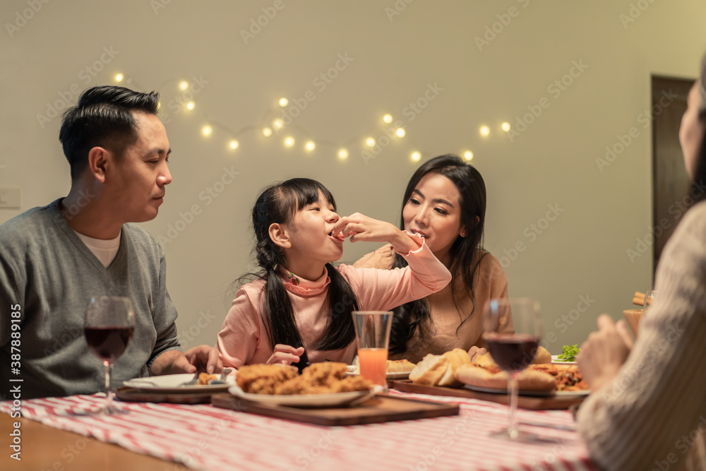 Asian young little girl enjoying her meal with crispy fried chicken.